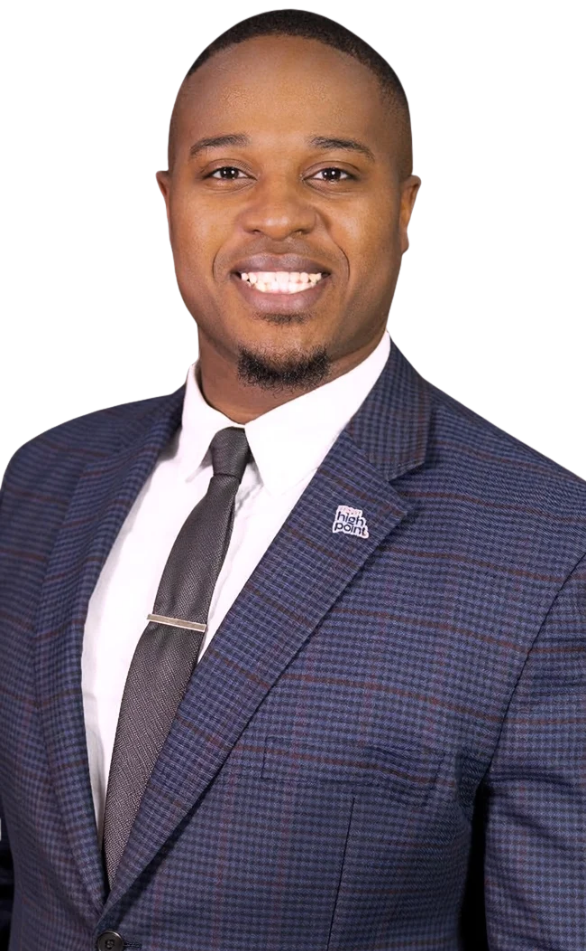 Portrait of Cyril Jefferson smiling in a navy suit, white shirt, and dark tie.